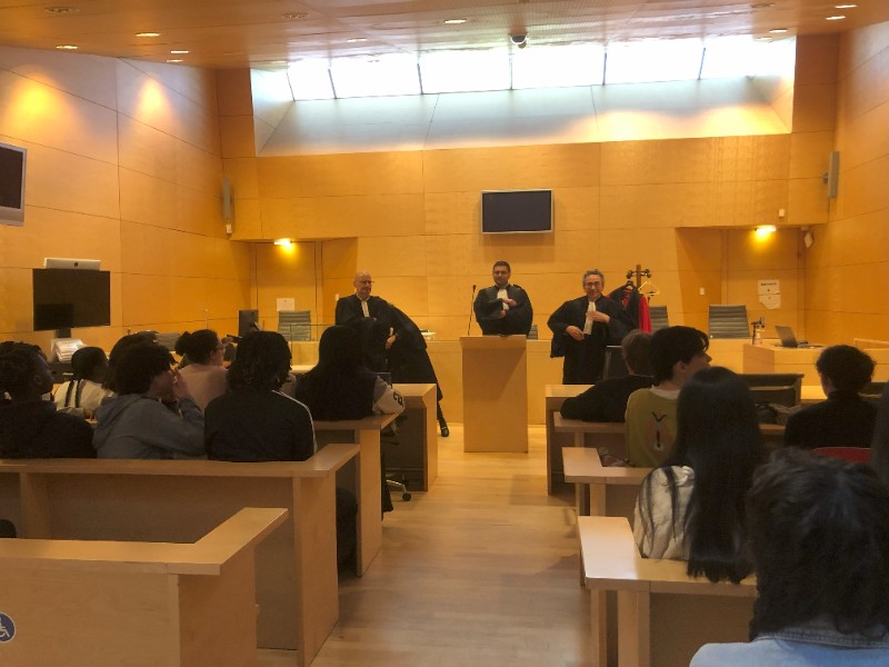 Les élèves sont assis en salle d'audience, attentifs aux échanges qu'ils ont avec les professionnels du barreau.